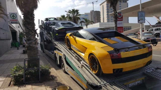 Car Carrier Being Loaded With Sports Cars